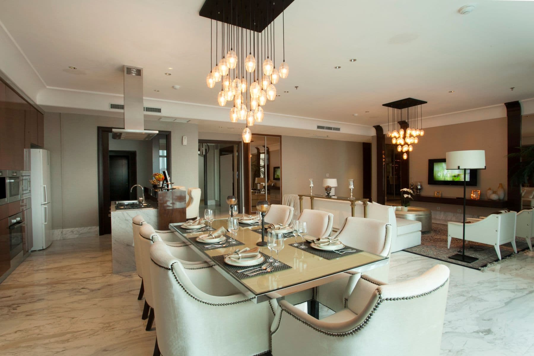 A statement pendant chandelier hanging above a dining table in an upscale home