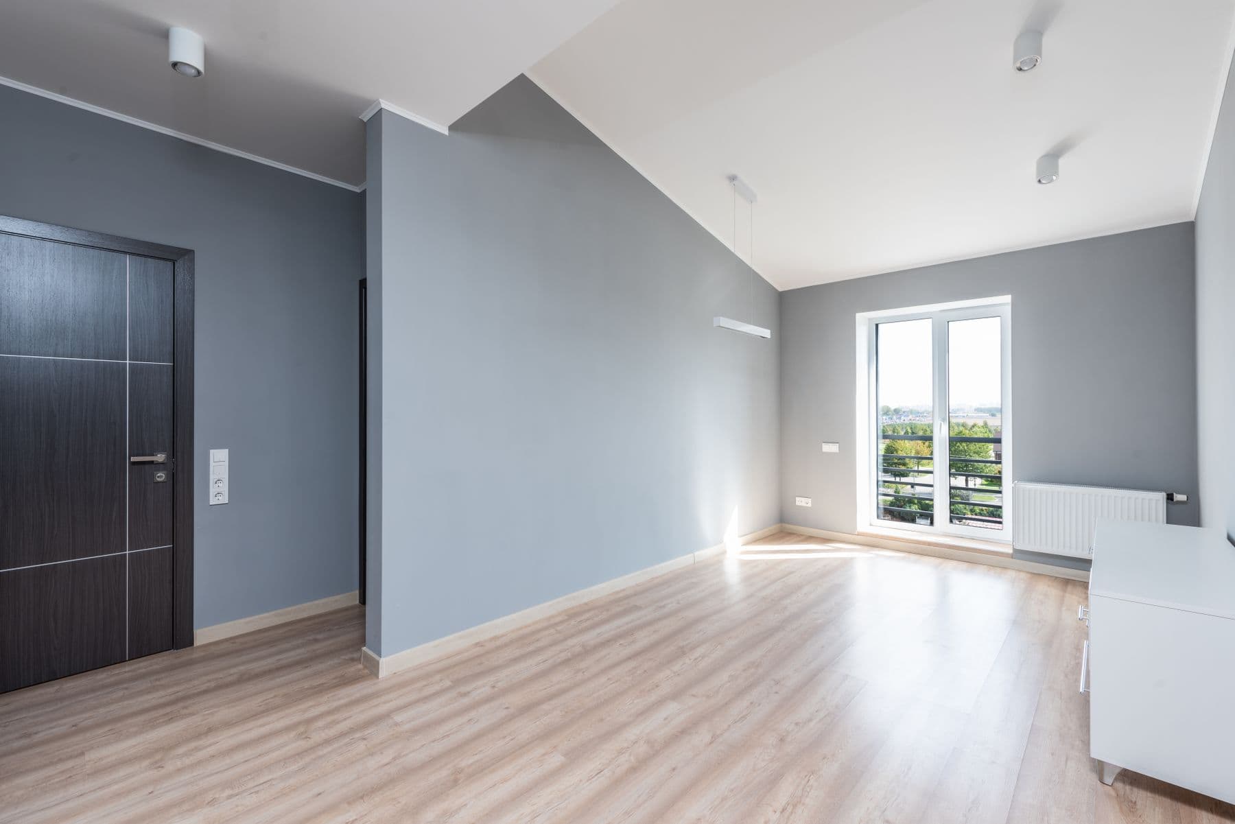 A large expanse of smooth, flawlessly finished painted wall in a bright room