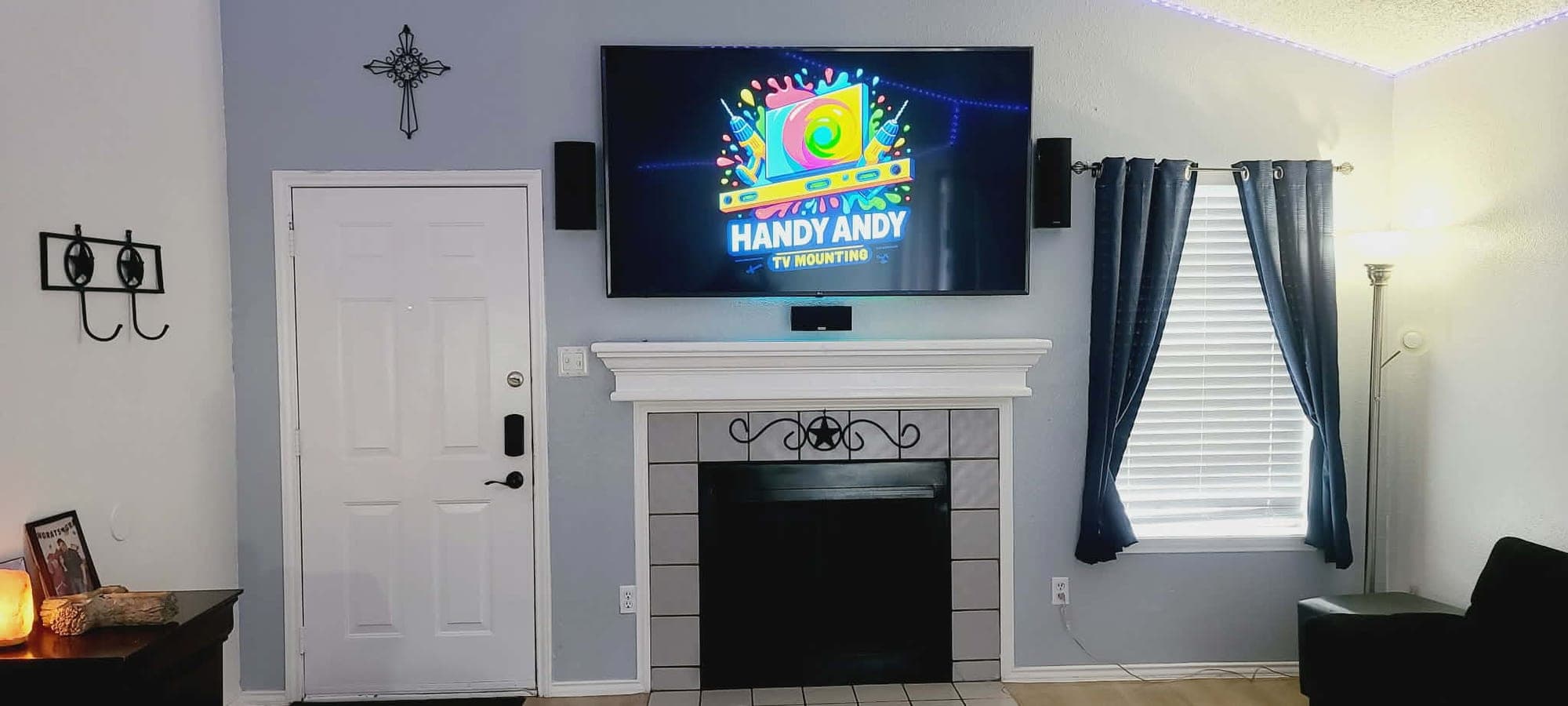 TV mounted above a white fireplace mantel with a soundbar in an Austin home