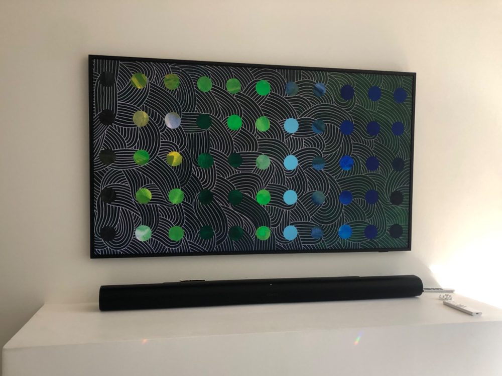 Samsung Frame TV showing dot artwork above a soundbar